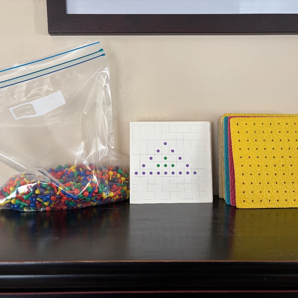 Vintage pegboards and design cards with colorful mini pegs; learning/educational